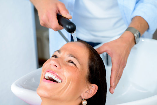 hairdresser washing womans hair
