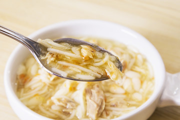 spoon with noodle soup and chicken