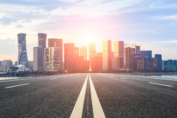 Asphalt highway and modern city buildings in hangzhou qianjiang new city at sunset