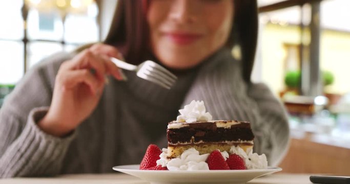 Happy Japanese woman indulges in fancy dessert