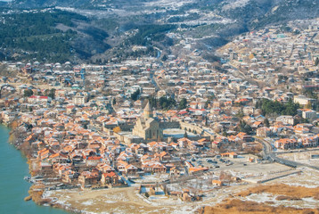 Panoramic view of Mtskheta, an old town at the confluence of two rivers Mtkvari And Aragvi and Svetitskhoveli Cathedral, ancient georgian orthodox church, Unesco heritage, on winter sunny day.