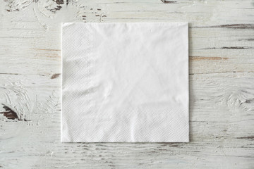 White paper napkin on wooden background