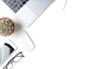 Desk with laptop, eye glasses, pencil and a small cactus