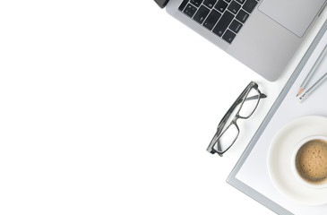 Desk with laptop, eye glasses, notebook and a cup of coffee isolated