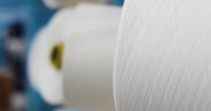 Industrial knitting machine producing cotton yarn