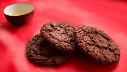 still life, a cup of tea and biscuits, on a red beautiful background with a divorce