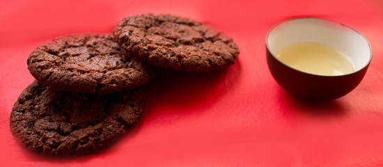 still life, a cup of tea and biscuits, on a red beautiful background with a divorce