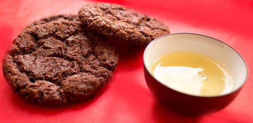 still life, a cup of tea and biscuits, on a red beautiful background with a divorce