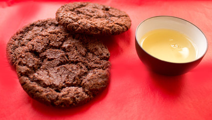 still life, a cup of tea and biscuits, on a red beautiful background with a divorce