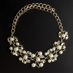 golden necklace with pearls isolated