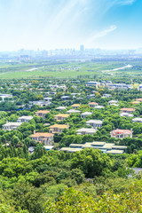 Fototapeta premium Residential buildings and green forest in Shanghai city suburbs,China,aerial view
