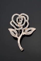 brooch rose flower with diamonds isolated on black