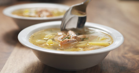 closeup eating fish soup with salmon