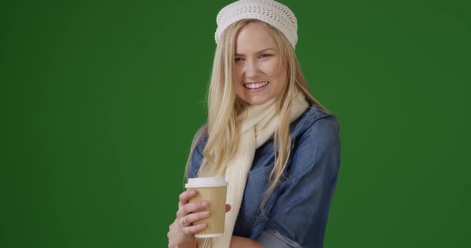 White Parisian looking girl with a coffee laughing at the camera on green screen. On green screen to be keyed or composited. 