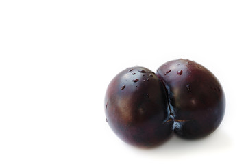 Double plum in the shape of buttocks isolated on white background