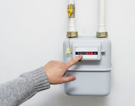 Person Reading The Gas Meter In The Private House, Counter For Distribution Domestic Gas. Cropped Image.