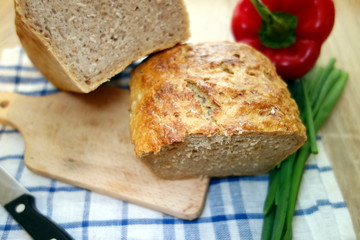 Traditional homemade bread on cutting board in the kitchen 