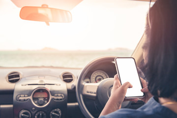 Tourist woman using smartphone in car with sea background