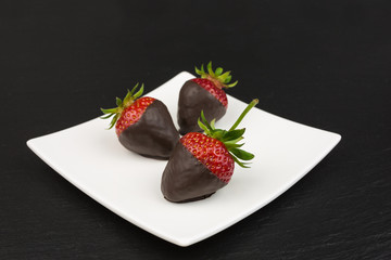 red strawberries dipped in dark chocolate