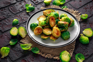 Homemade Roasted Brussel Sprouts with Salt, Pepper on a old stone rustic table.