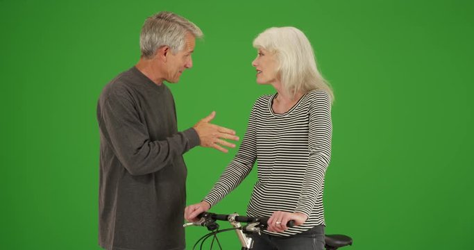 Senior strangers talking and getting to know each other on green screen. On green screen to be keyed or composited. 