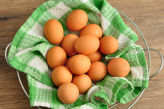 Eggs in a green cloth inside a wire basket