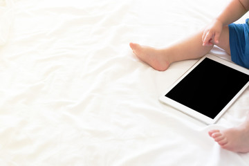 Cute baby with a tablet, copy space image