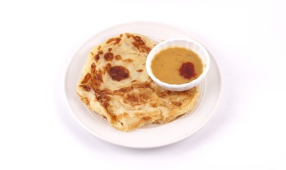 Malaysian favorite breakfast meal. Roti canai or flatbread with dhal curry isolated on white