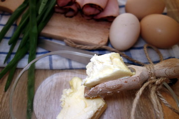 Butter portion on wooden scoop in the kitchen