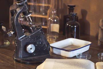 Antique laboratory,  old microscope and  glassware with selective focus. Science and medical...