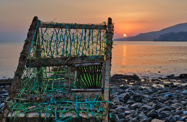 Old, abandoned fisherman's trap witnessing the sunrise.