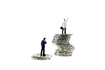 Miniature people : businessman standing on top of coin on white background