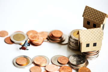 Miniature People : businessman walking between stack of coins