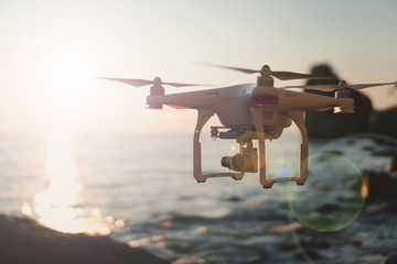 The drone in the sunset sky. ocean wave mountains Close up of quadrocopter outdoors. concept for film maker wedding videography aerial photographer. equipment for vlog blog, old,