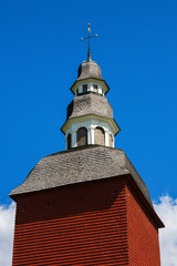 Fototapeta na wymiar Red bell tower against blue sky