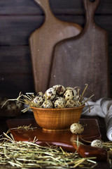 quail eggs in a wooden bowl