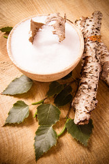 Xylitol - sugar substitute. Birch sugar on wooden background.