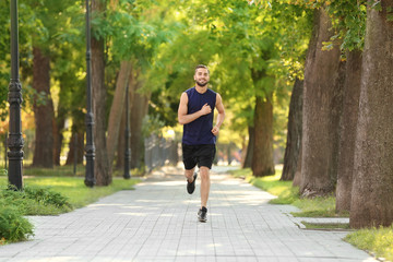 Sporty young man running outdoors