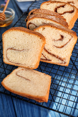 Baking rack with delicious cinnamon roll cake on table