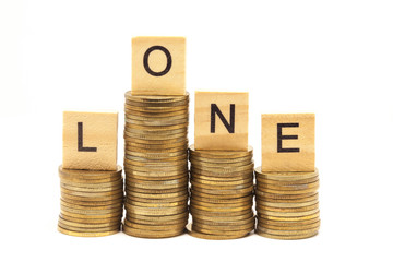 Word Loan Concept on wooden block over on stacked coins.