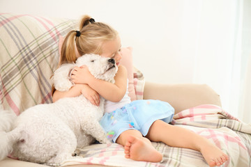 Adorable little girl with her dog at home