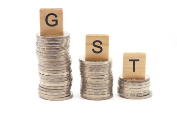Goods and Services Tax word on stack coins isolate .