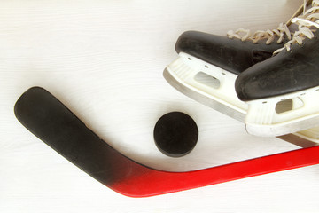 sports equipment for winter games/ flat layout of old skates, hockey puck and putter on a light...
