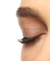 Woman with closed eyes and long eyelashes on white background, closeup
