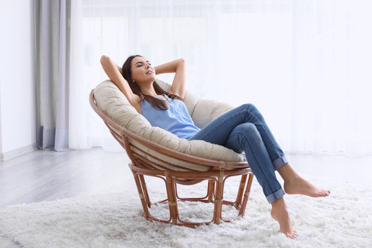 Young Woman Resting In Lounge Chair At Home