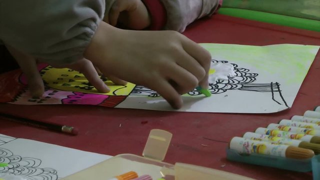 A Chinese little girl is is learning painting