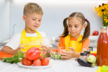 children prepare vegetable salad for lunch