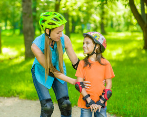 Mother teaches daughter rollerblading