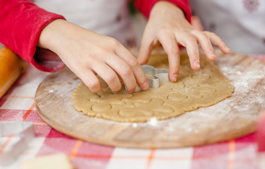 close-up of baby's hand cut out dough cookies