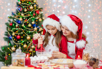 Mom's daughter in Christmas caps bakes cookies at home